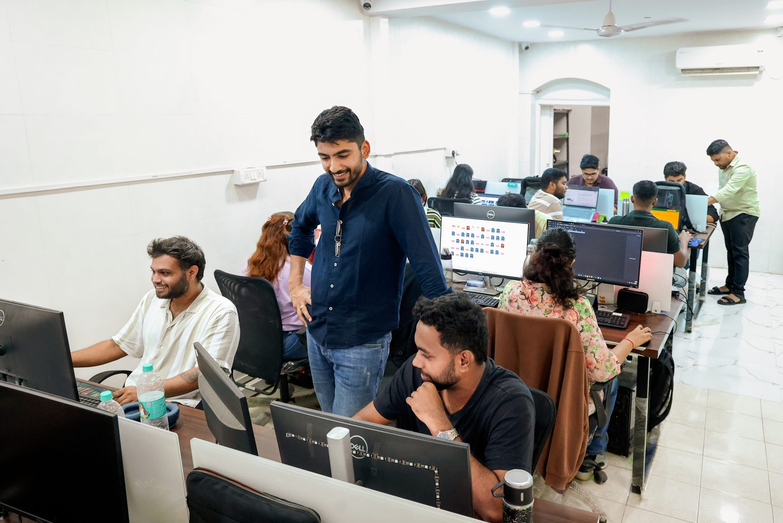 Manan reviewing work with the team